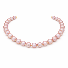 Qalereya görüntüsünə şəkil yükləyin, Pearl necklace with gold clasps on a white background
