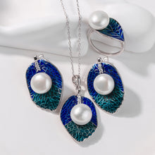 Qalereya görüntüsünə şəkil yükləyin, Jewelry set with blue enamel leaves and pearl centers on a white background
