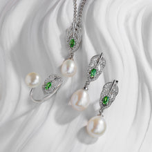 Qalereya görüntüsünə şəkil yükləyin, Pearl jewelry set with green gemstones on a white fabric background
