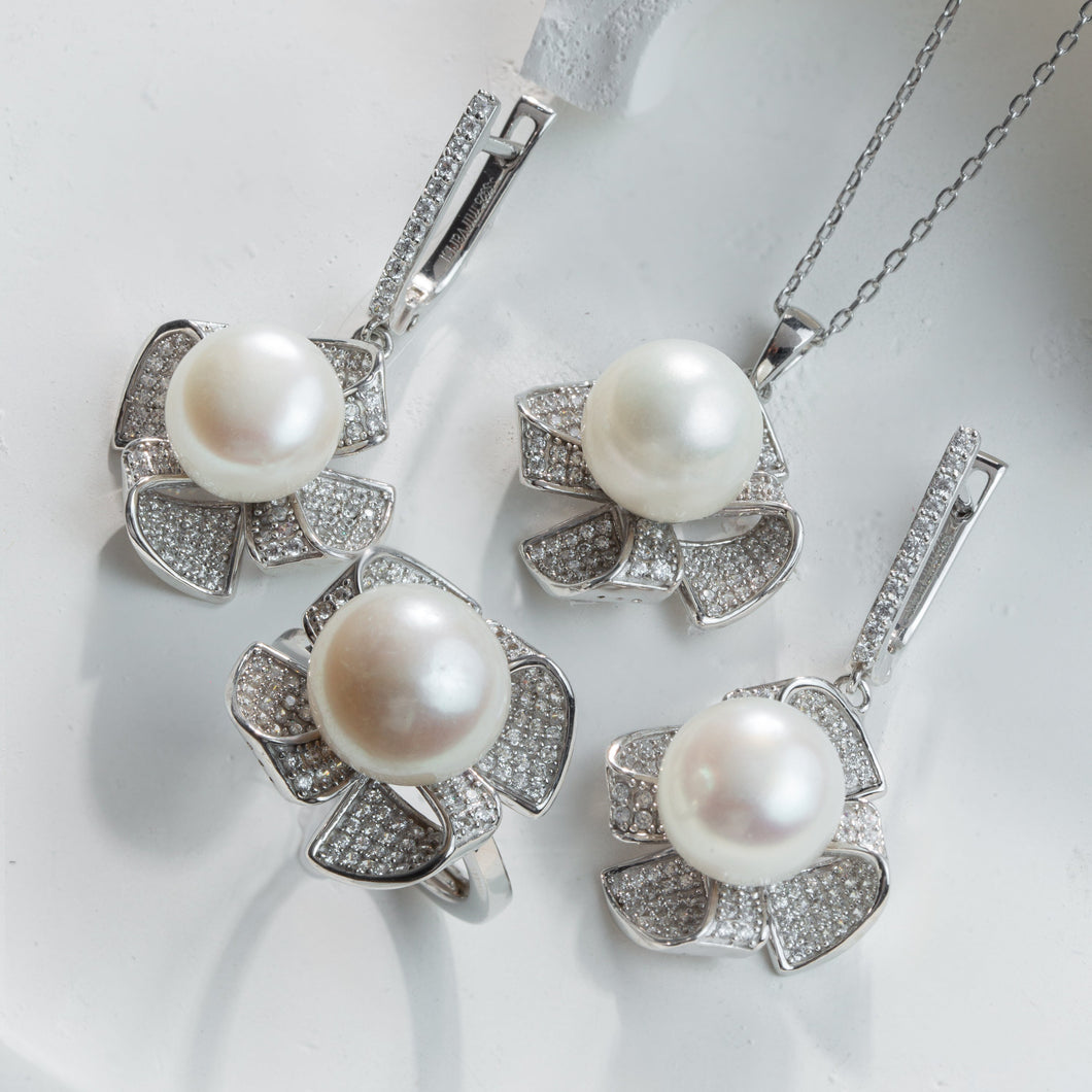 Pearl necklace and earrings set on a white background