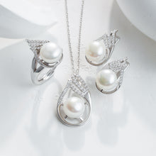 Qalereya görüntüsünə şəkil yükləyin, Pearl necklace and earrings set on a white surface
