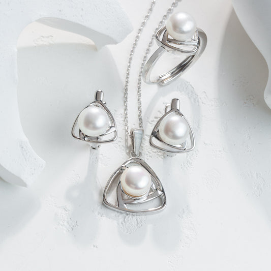 Pearl jewelry set with necklace, ring, and pendants on a white background