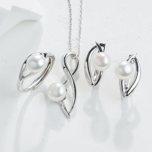 Silver jewelry set with pearls on a white background