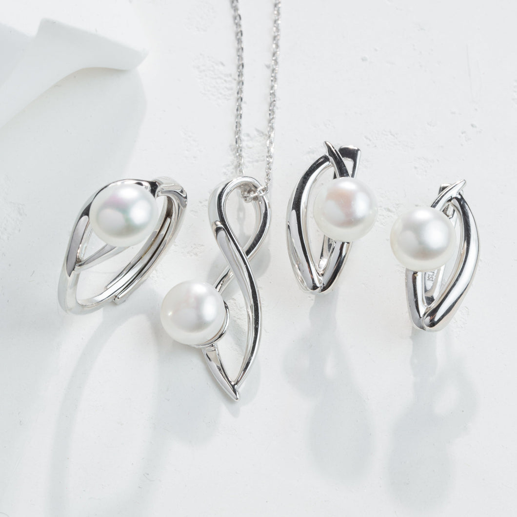 Silver jewelry set with pearls on a white background