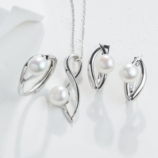 Silver jewelry set with pearls on a white background