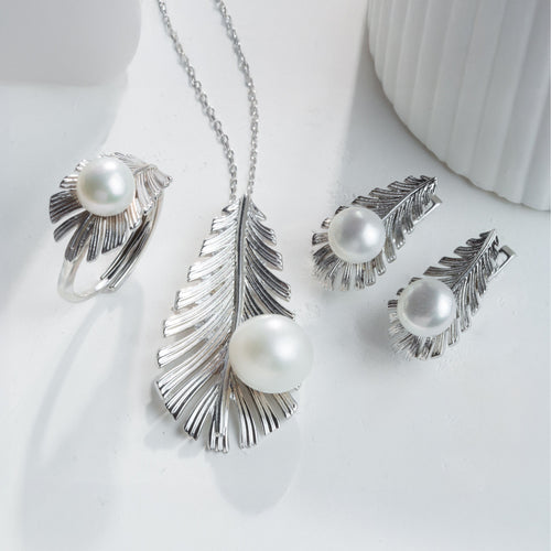 Silver jewelry set with pearls on a white background