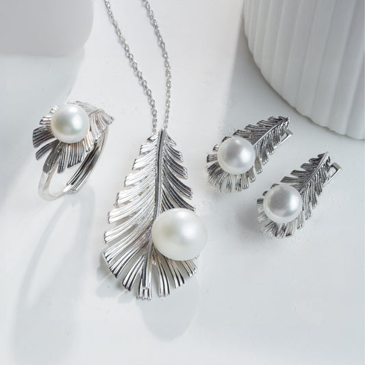 Silver jewelry set with pearls on a white background