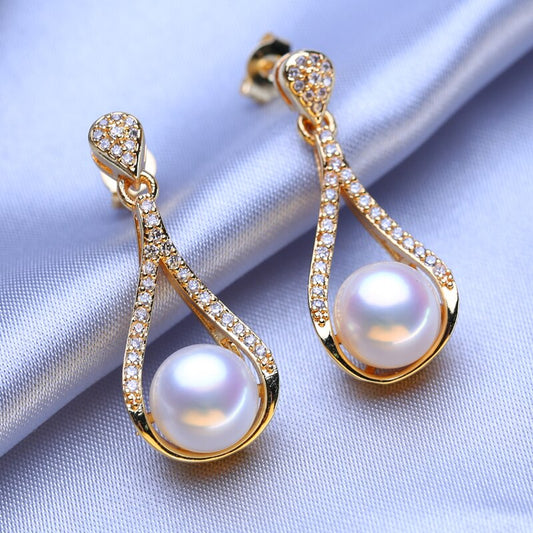 Qızıl örtüklü zirkon qaşlarla bəzədilmiş sırğa